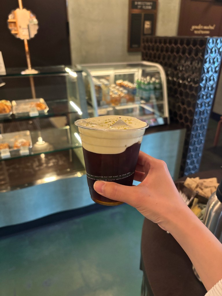 Hajeong Hwang holding an iced coffee in a cafe